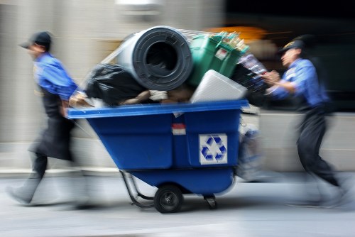 Professional removal team disposing of a bed